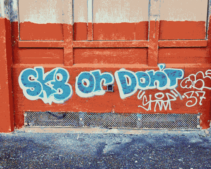 Bubble letter graffiti on a wall reading "Sk8 or don't
